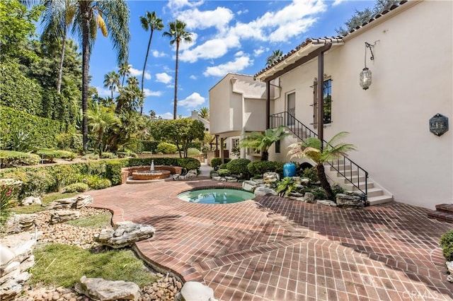 view of swimming pool featuring an in ground hot tub and a patio area