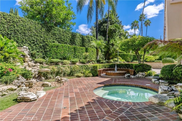 view of pool with an in ground hot tub and a patio area