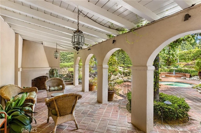 view of patio / terrace featuring exterior fireplace and ceiling fan