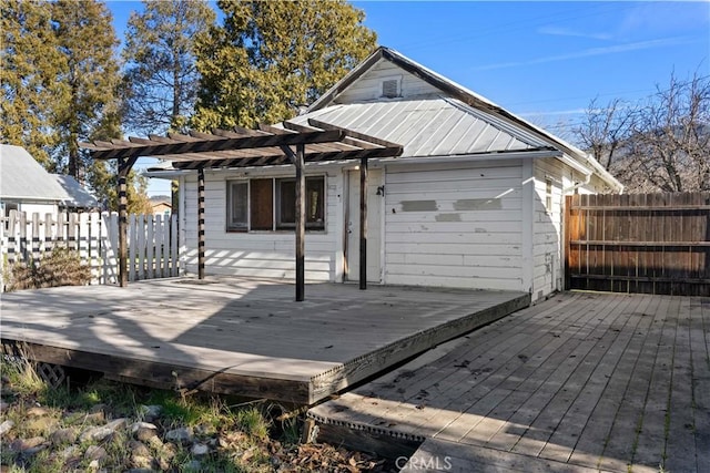 back of property featuring a pergola and a deck