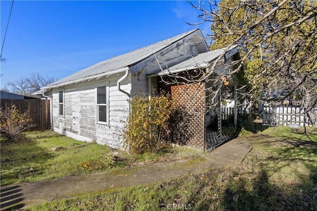 view of side of property with a lawn