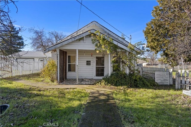 bungalow-style house with a front lawn