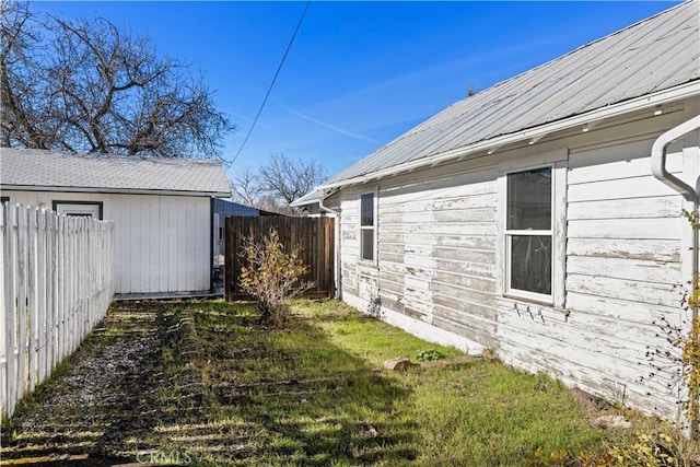 view of property exterior featuring an outbuilding and a yard