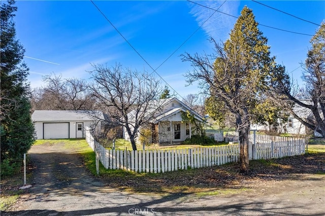 view of front of home with a garage and an outdoor structure