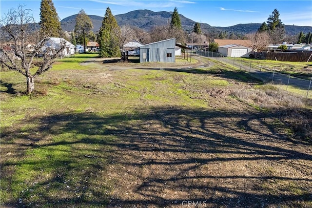 view of yard featuring an outbuilding and a mountain view