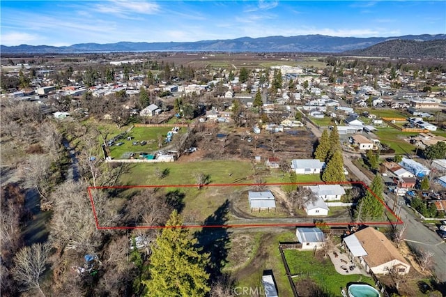 birds eye view of property featuring a mountain view