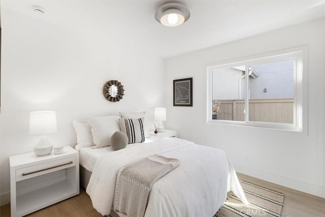 bedroom with wood-type flooring