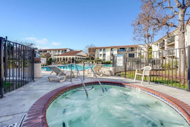 view of pool featuring a hot tub