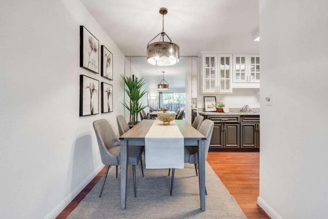 dining space featuring light hardwood / wood-style floors and sink