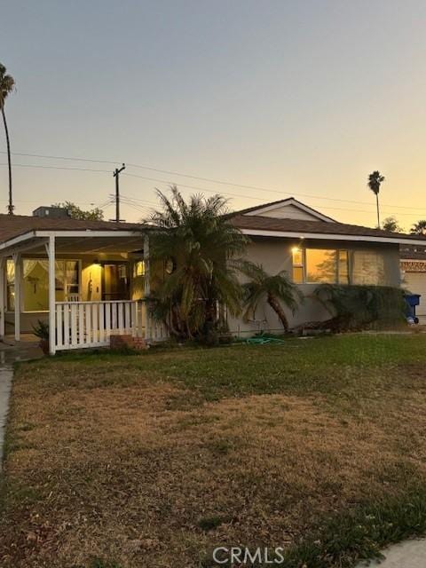 view of front of house featuring a yard and a porch