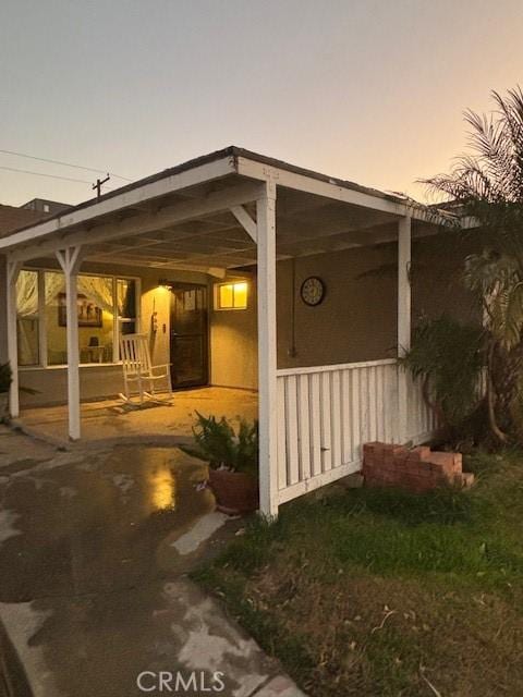 property exterior at dusk with covered porch