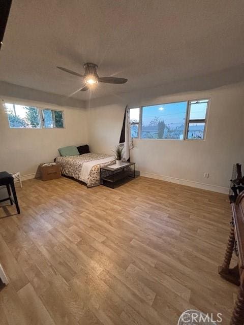 bedroom featuring ceiling fan and light hardwood / wood-style flooring