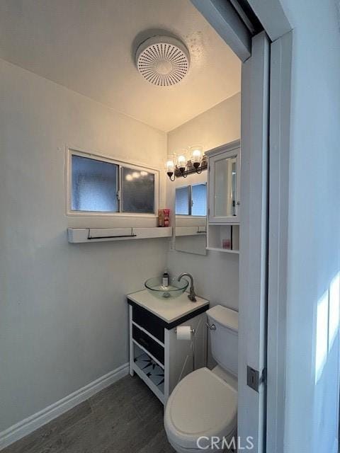 bathroom featuring toilet and vanity