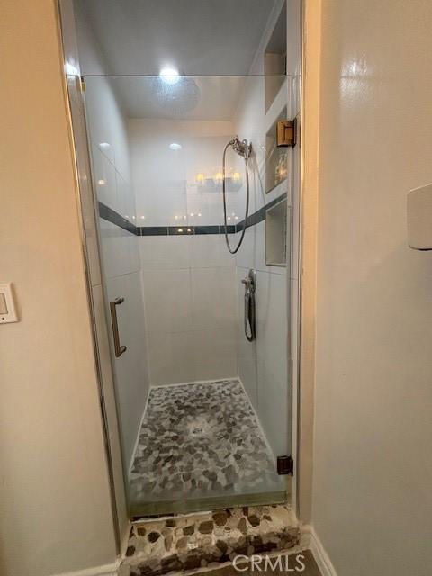 bathroom with a shower with door