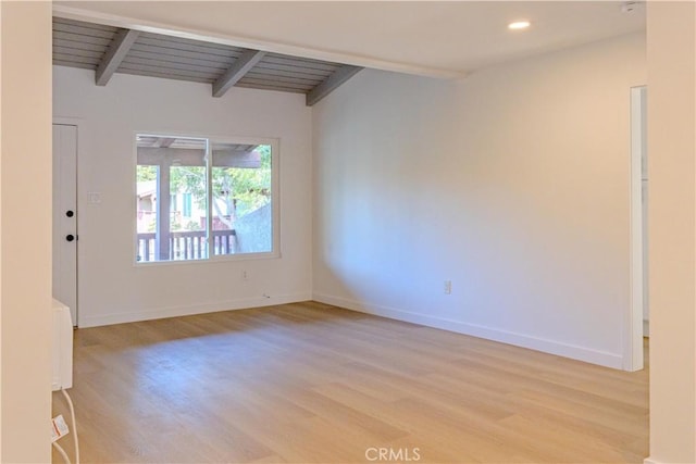 unfurnished room featuring wooden ceiling, vaulted ceiling with beams, and light hardwood / wood-style floors