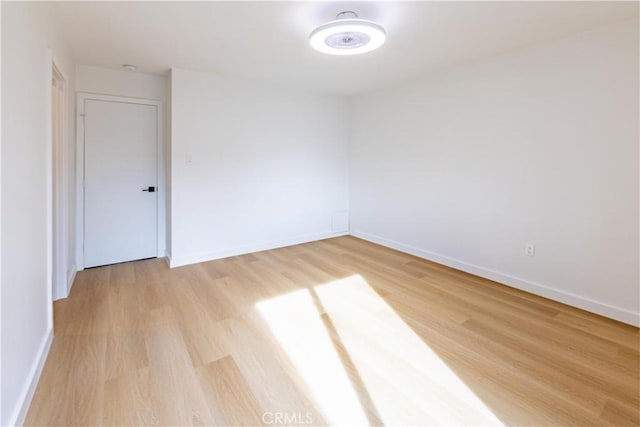 unfurnished room with light wood-type flooring