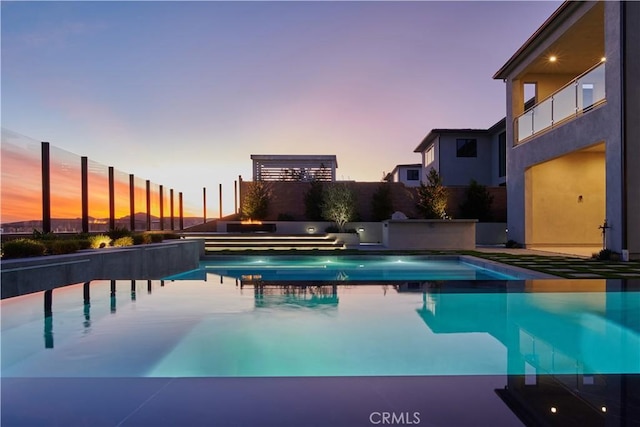 view of pool at dusk