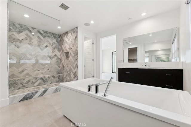 bathroom with plus walk in shower, tile patterned flooring, and vanity