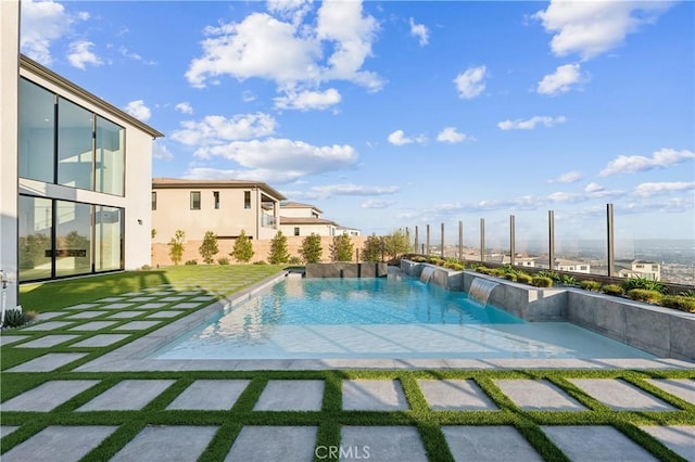 view of swimming pool with pool water feature and a patio area