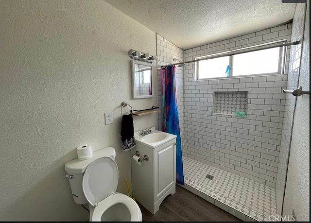 bathroom with toilet, hardwood / wood-style floors, a textured ceiling, a shower with curtain, and vanity