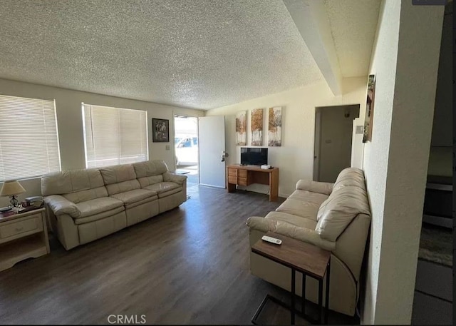 living room featuring a textured ceiling, dark hardwood / wood-style flooring, and beamed ceiling