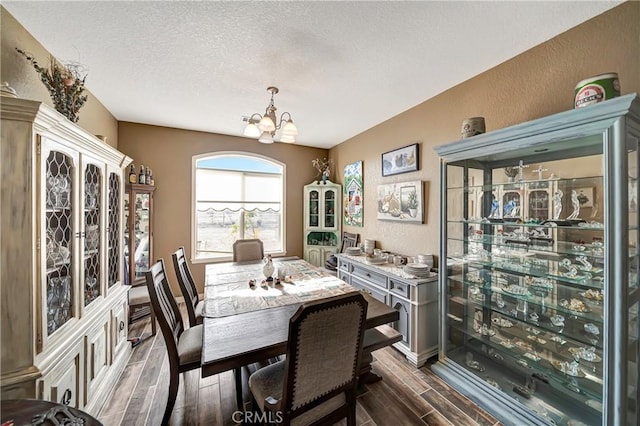 dining room with an inviting chandelier and a textured ceiling