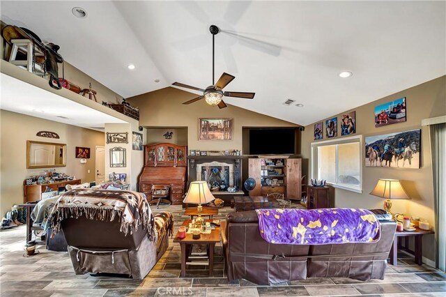 living room featuring ceiling fan and vaulted ceiling