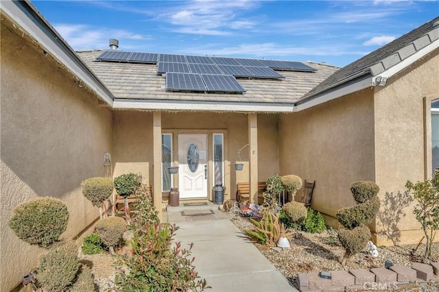 doorway to property featuring solar panels