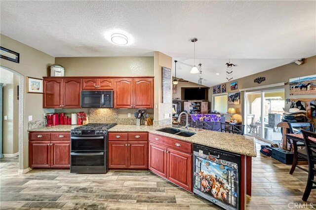 kitchen with kitchen peninsula, dishwashing machine, range with two ovens, pendant lighting, and sink