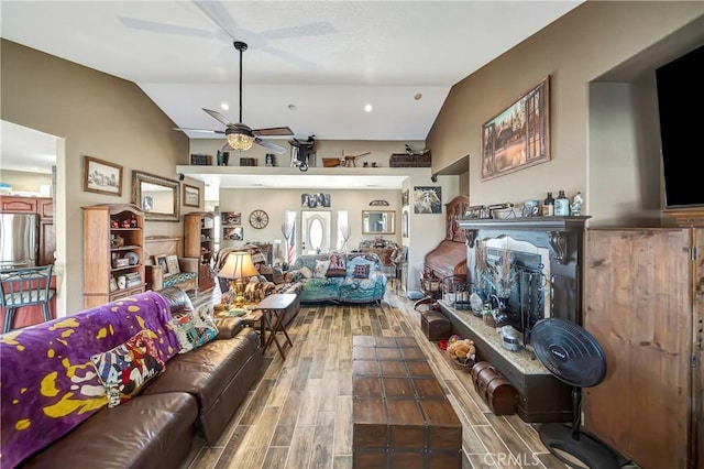 living room featuring ceiling fan and lofted ceiling