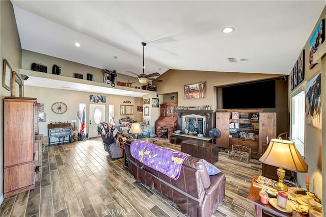 living room with ceiling fan and vaulted ceiling