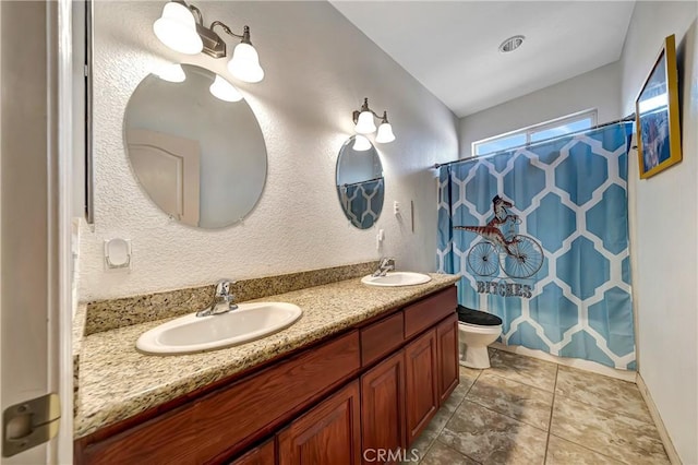 bathroom with toilet, vanity, and curtained shower