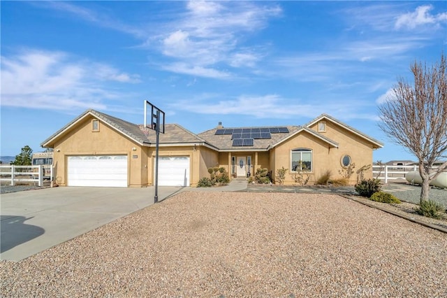 ranch-style house with solar panels and a garage