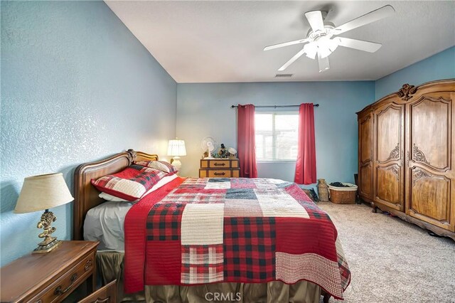 carpeted bedroom with ceiling fan