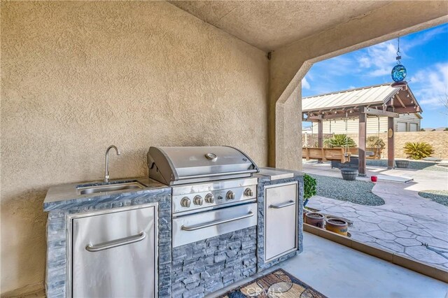 view of patio / terrace with exterior kitchen, sink, and area for grilling