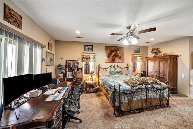 bedroom with ceiling fan, light colored carpet, and multiple windows