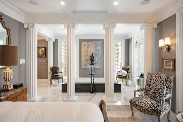 bedroom featuring crown molding and ornate columns