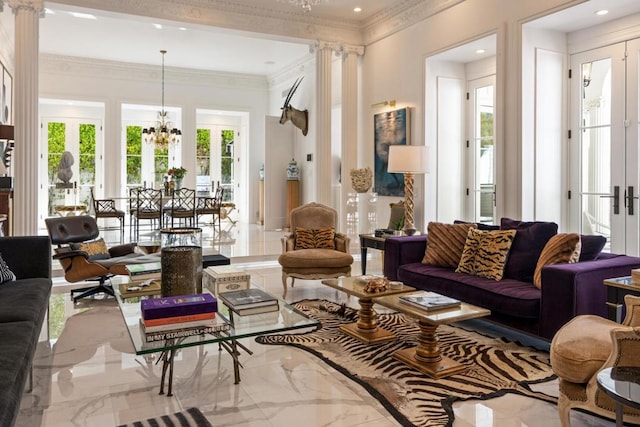 living room featuring decorative columns, a notable chandelier, crown molding, and french doors