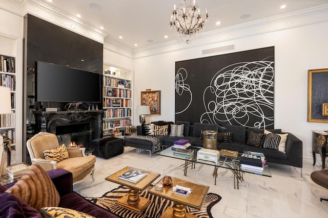 living room featuring a chandelier, crown molding, a fireplace, and built in shelves