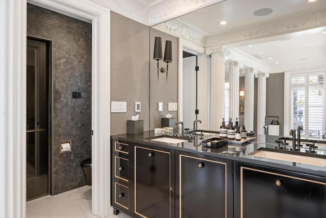 bathroom featuring toilet, vanity, and ornamental molding