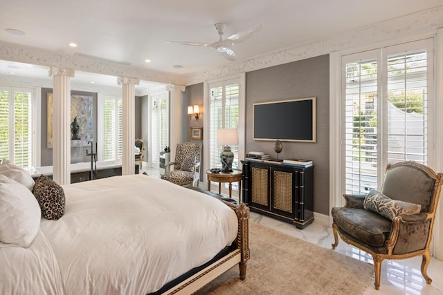 bedroom with decorative columns and ceiling fan