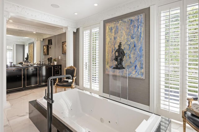 bathroom featuring a healthy amount of sunlight, vanity, and a washtub