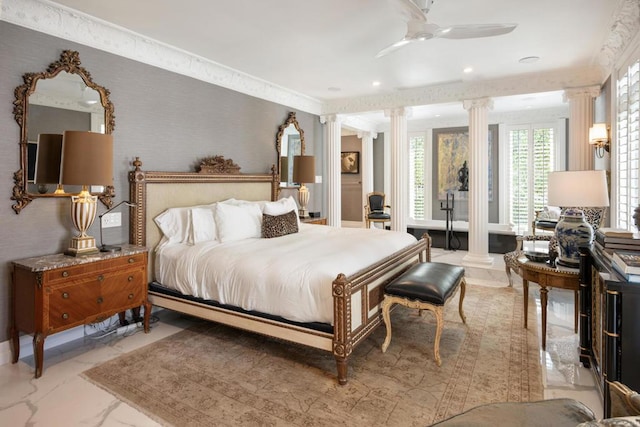 bedroom with ceiling fan and decorative columns