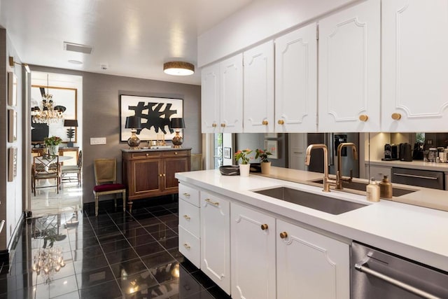 kitchen with sink, white cabinetry, and stainless steel dishwasher