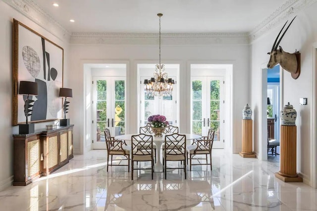 dining room with crown molding, french doors, and an inviting chandelier