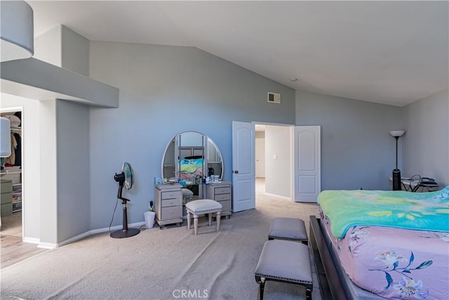 carpeted bedroom with a spacious closet and lofted ceiling