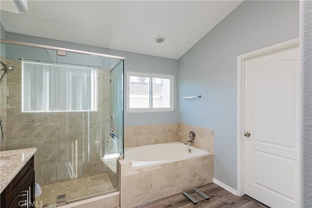 bathroom featuring vaulted ceiling, shower with separate bathtub, wood-type flooring, and vanity