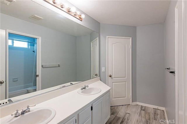 full bathroom featuring toilet, shower / bathtub combination, and vanity