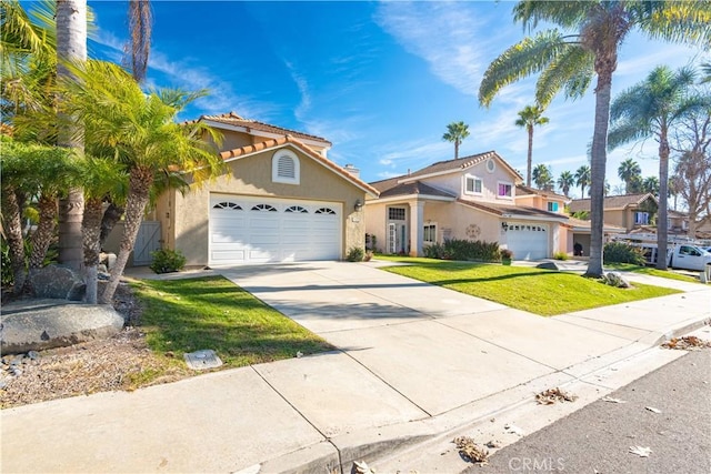 view of front of home featuring a garage and a front lawn