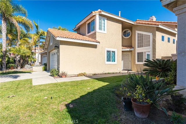 rear view of property with a garage and a yard